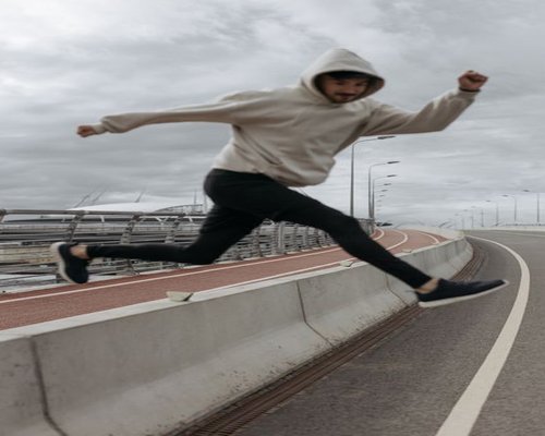 Person modeling the Momentum Weekend Hoodie in the city