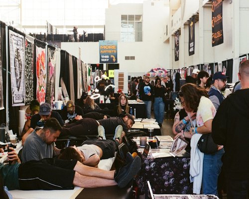 Spectators engaging with gaming technology at a public exhibition